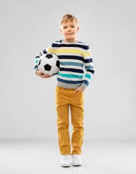 Boy in striped pullover with soccer ball Stock Photos
