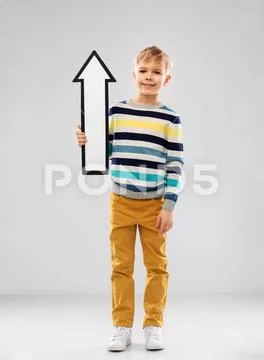 Boy in striped pullover with upwards thick arrow Stock Photos