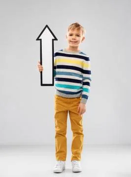 Boy in striped pullover with upwards thick arrow Stock Photos