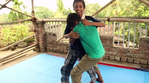 Boy struggles and strikes as another practices a take-down on him. Stock Footage 58471516