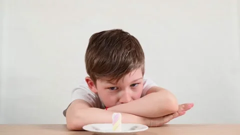 Boy struggles to win marshmallow experiment clapping hands Stock Footage 130742462