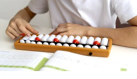 Boy student doing mental arithmetic on the abacus Stock Photos