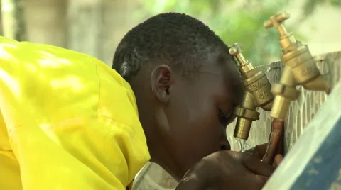 BOY STUDENT DRINKS WATER FROM HANDS AT FAUCETS 2 Stock Footage 59865215