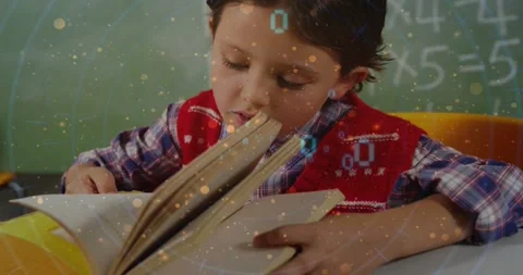 Boy student leaning and turning pages at desk, studying math with binary overlay Stock Footage 330981208
