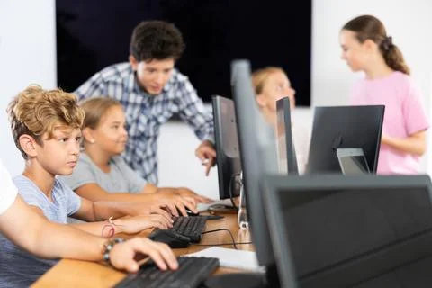 Boy student learning to work on computer in classroom Foto stock