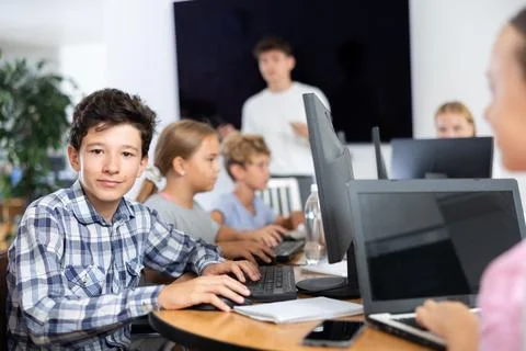 Boy student learning to work on computer in classroom Foto stock