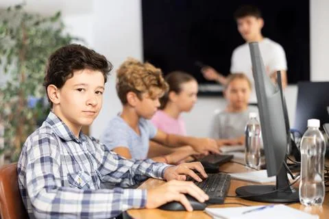 Boy student learning to work on computer in classroom 스톡 사진