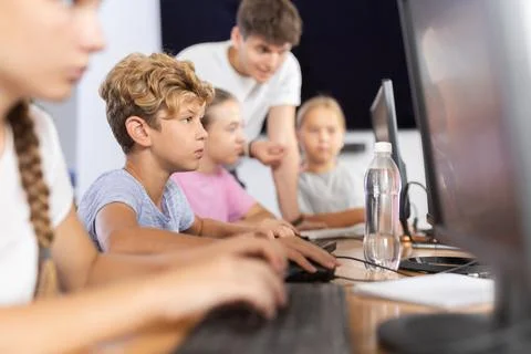 Boy student learning to work on computer in classroom 스톡 사진