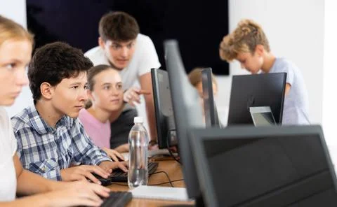 Boy student learning to work on computer in classroom Foto stock