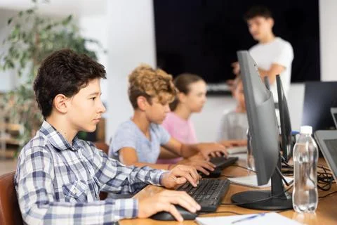 Boy student learning to work on computer in classroom 스톡 사진