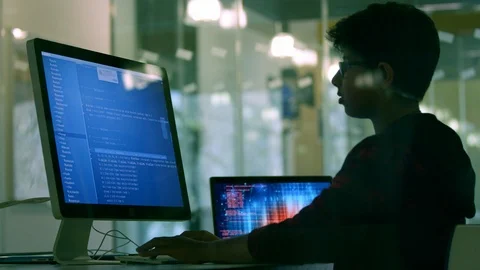 Boy student programming at computer in computer lab classroom Stock Footage