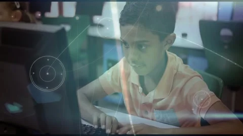 Boy student typing upon onscreen cue in classroom, HUD streaking across monitor Stock Footage 331214115