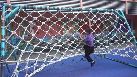 Boy students climbing on the robe at school slow motion HD Stockbeeldmateriaal 86169266
