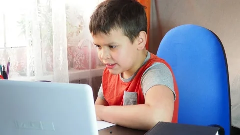 Boy studies at the computer remote education, do homework, learning online Stock Footage 141467272
