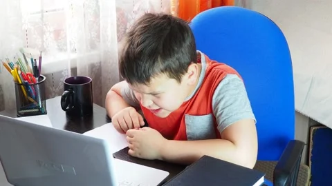 Boy studies at the computer remote education, do homework, learning online 库存影片 141468370