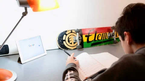 Boy studies in his room using ipad. Stock Footage 98756611