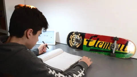 Boy studies in his room using ipad. Stock Footage 98756745