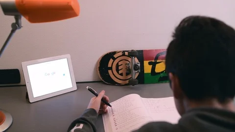 Boy studies in his room using ipad. Stock Footage 98756925