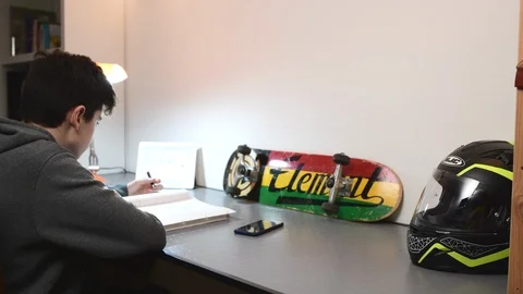 Boy studies in his room using ipad. Stock Footage 98756927