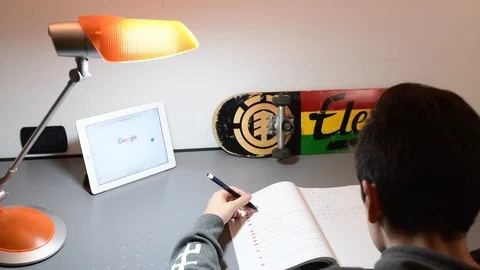 Boy studies in his room using ipad. Stock Footage 98756969