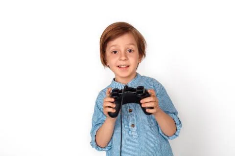 Boy studio standing isolated on grey with game controller playing game excited Stock Photos