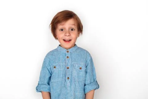 Boy studio standing isolated on grey looking camera impressed Stock Photos