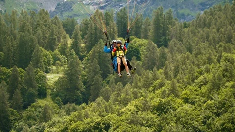 Boy study paragliding with instructor, flying with parachute high. Video stock 128185543