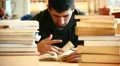 Boy studying among the books HD Footage