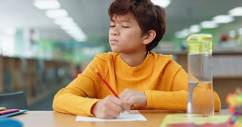 Boy, studying and thinking for math at library in school with notebook for Stock Footage 280462288