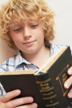 Boy studying bible Stock Photos