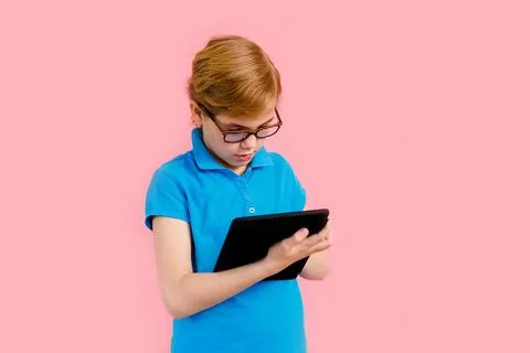 Boy studying homework with tablet pc during his online lesson at home, soci.. Stock Photos