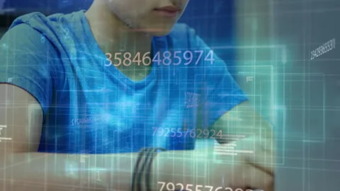 Boy studying at laptop, typing commands and activating holographic malware Stock Footage 314717193