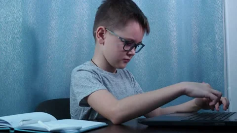 The boy is studying at the table. Turns and shows the OK sign Stock Footage 144468005