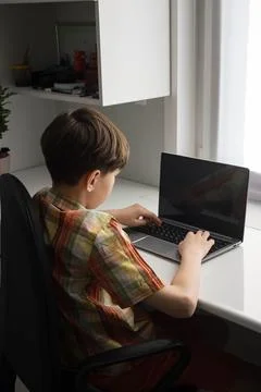 Boy studying working learning at desk using laptop computer 스톡 사진