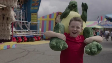 Boy with stuffed fair prize Stock Footage