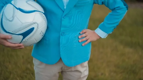 Boy in a Suit Holding a Ball Stock Footage 68791713