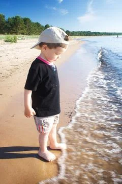 Boy on the summer beach Stock Photos