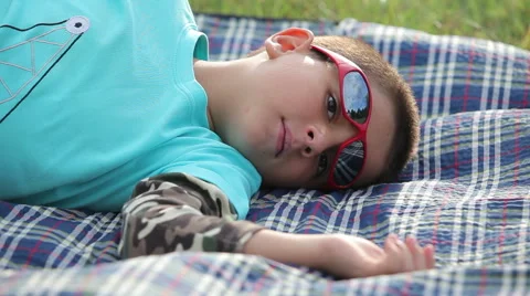 A boy in sunglasses looks in the sky Stock Footage 69007195