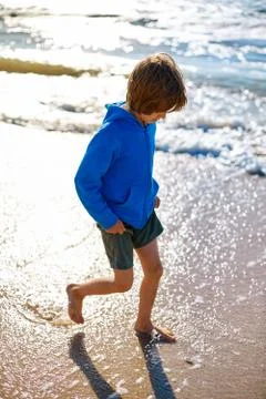 Boy on the sunny beach Stock Photos