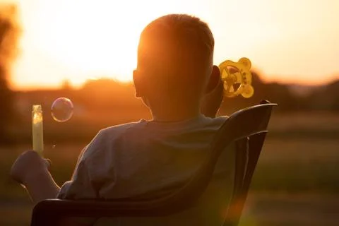 Boy at sunset  Stock Photos