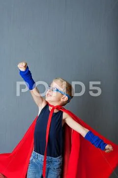 Boy in super hero costume pretending to fly Stock Photos