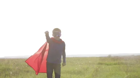 Boy superhero in a field at sunset Stock Footage 64051885