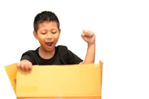 Boy surprised by opening parcel box isolated in clipping path. Stock Photos
