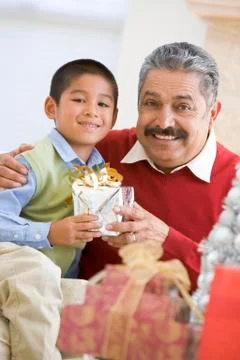 Boy Surprising Father With Christmas Present Stock Photos