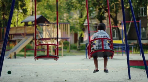 Boy swaying at swing on playground Видео 24861914