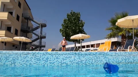 Boy in a swimming cap, took a run and closed nose jumped into the pool Video stock 5296027