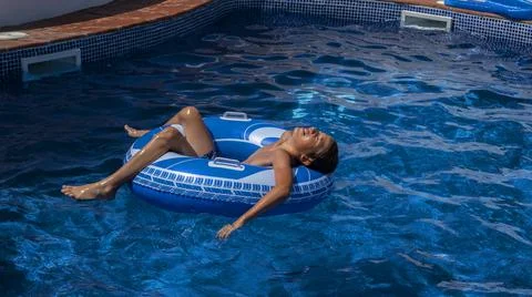 Boy swimming in circle in the pool Stock Photos