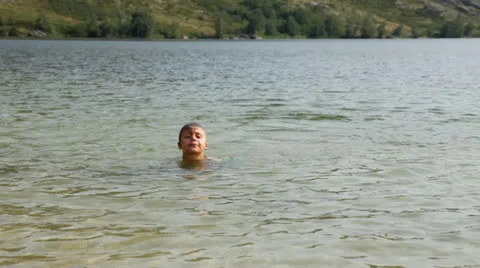 Boy swimming in the lake Stock Footage 27083246