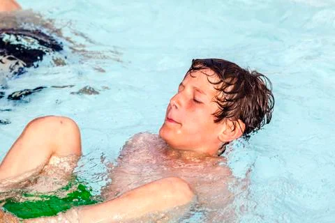 Boy swimming in the pool Stock Photos
