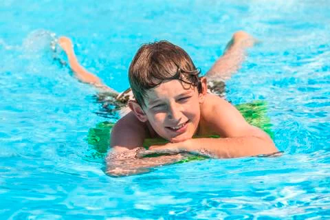 Boy swimming in the pool Stock Photos